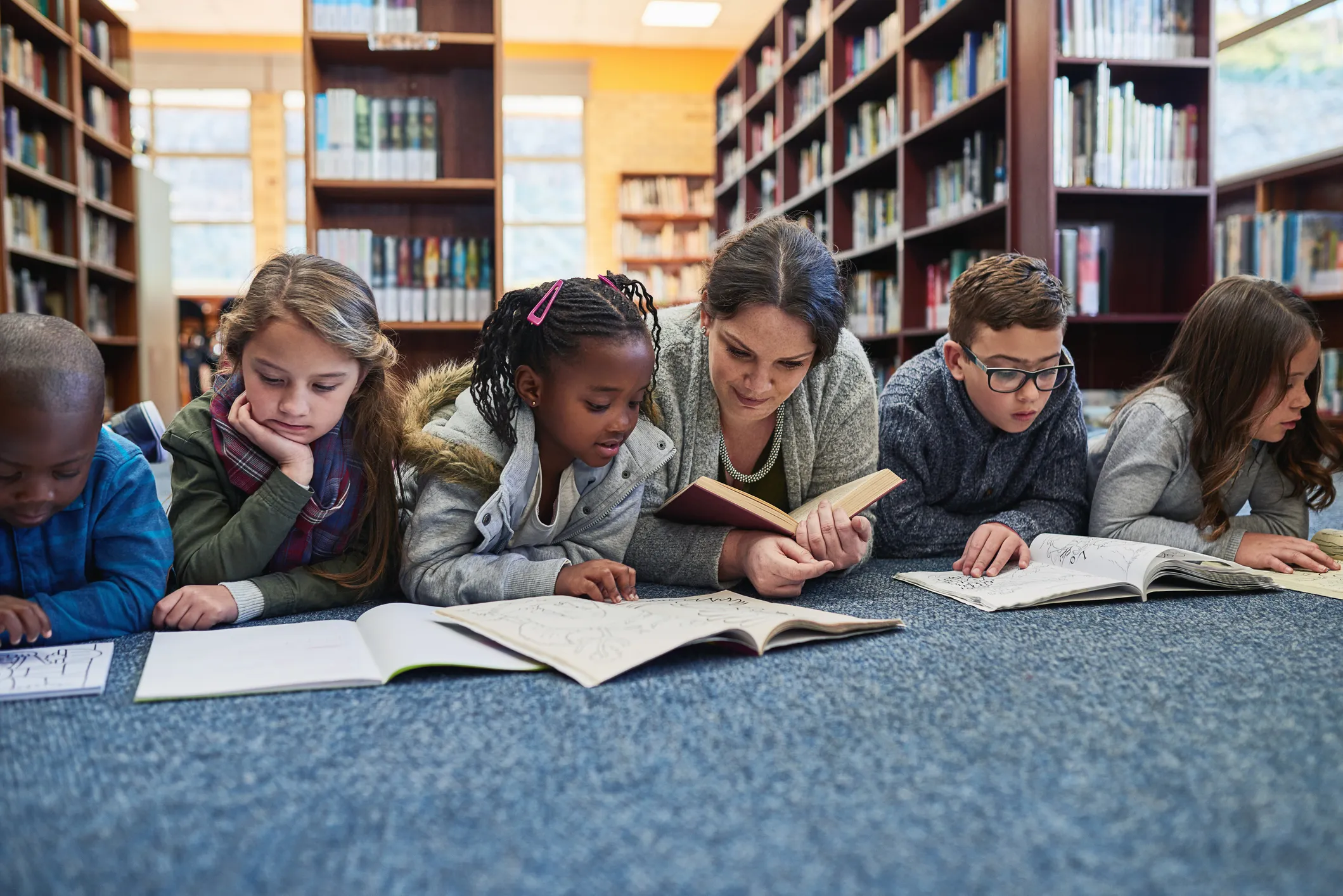 kids reading on the floor of a library