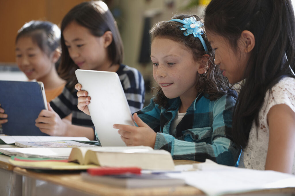 students reading on tablets in classroom
