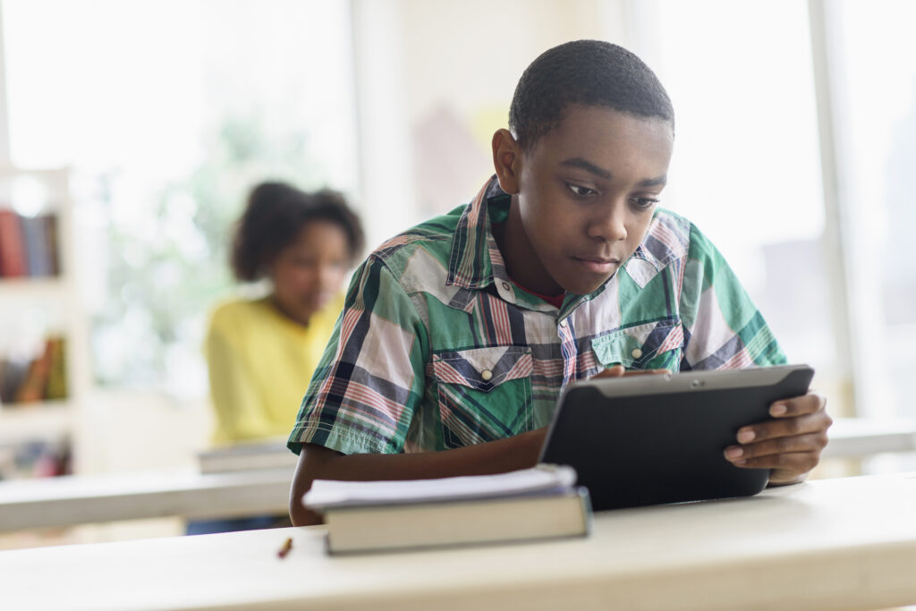 preteen boy on tablet