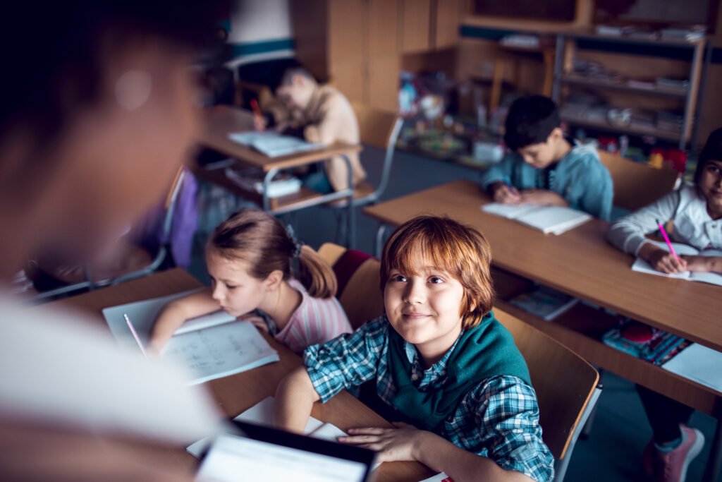 teacher helping her class with schoolwork