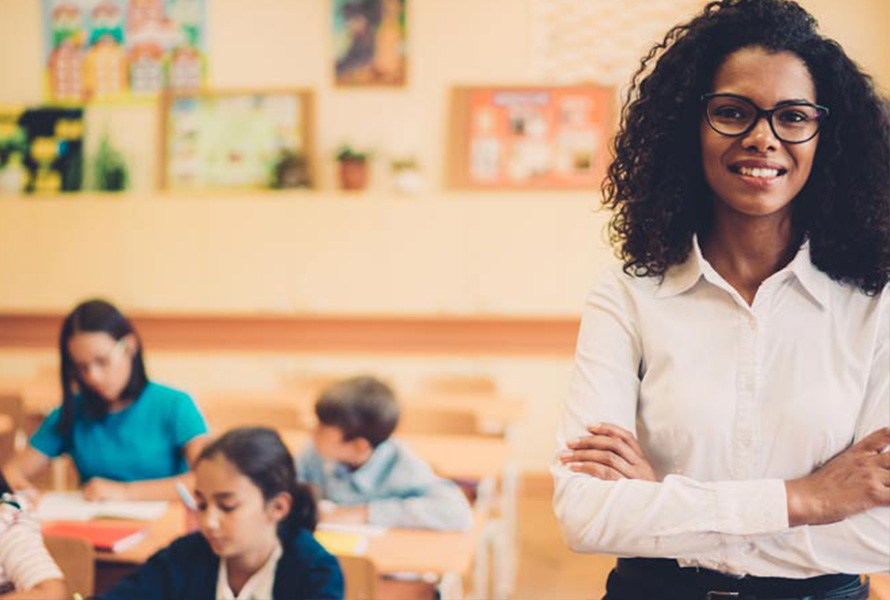 teacher in classroom with students in background