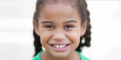 girl smiling in front of white background