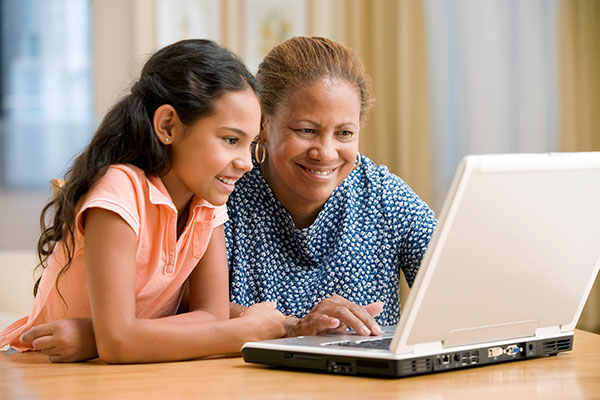 Teacher and girl on laptop