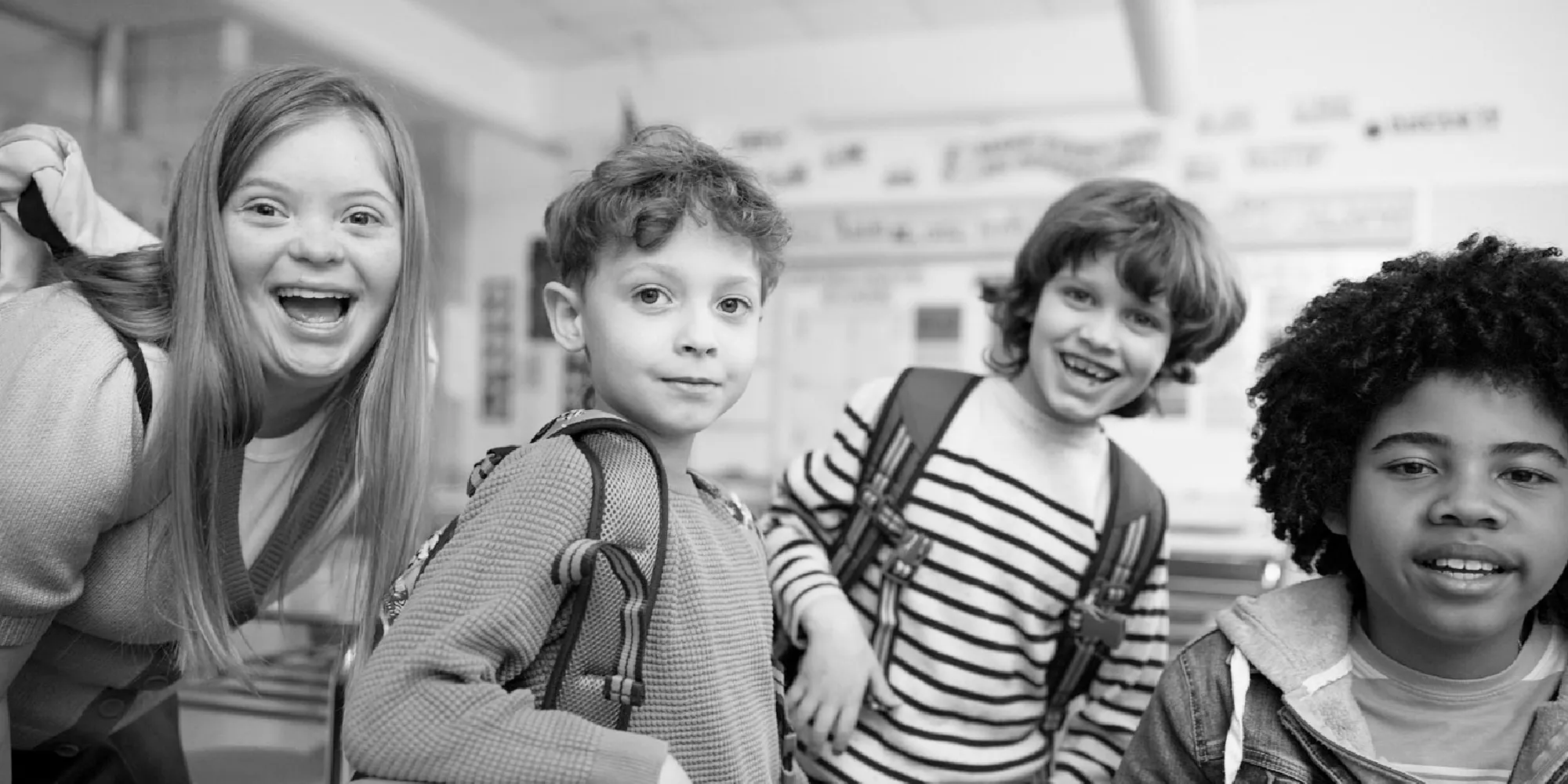 happy kids in a classroom looking at the viewer