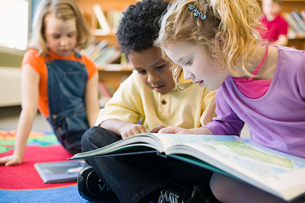 Group of young students reading