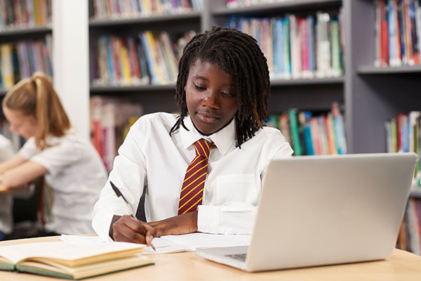 Teen working in library