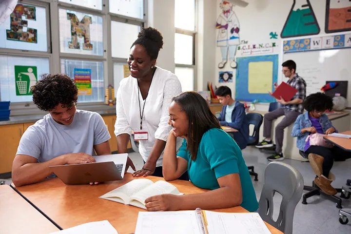 Teacher working with students in a classroom