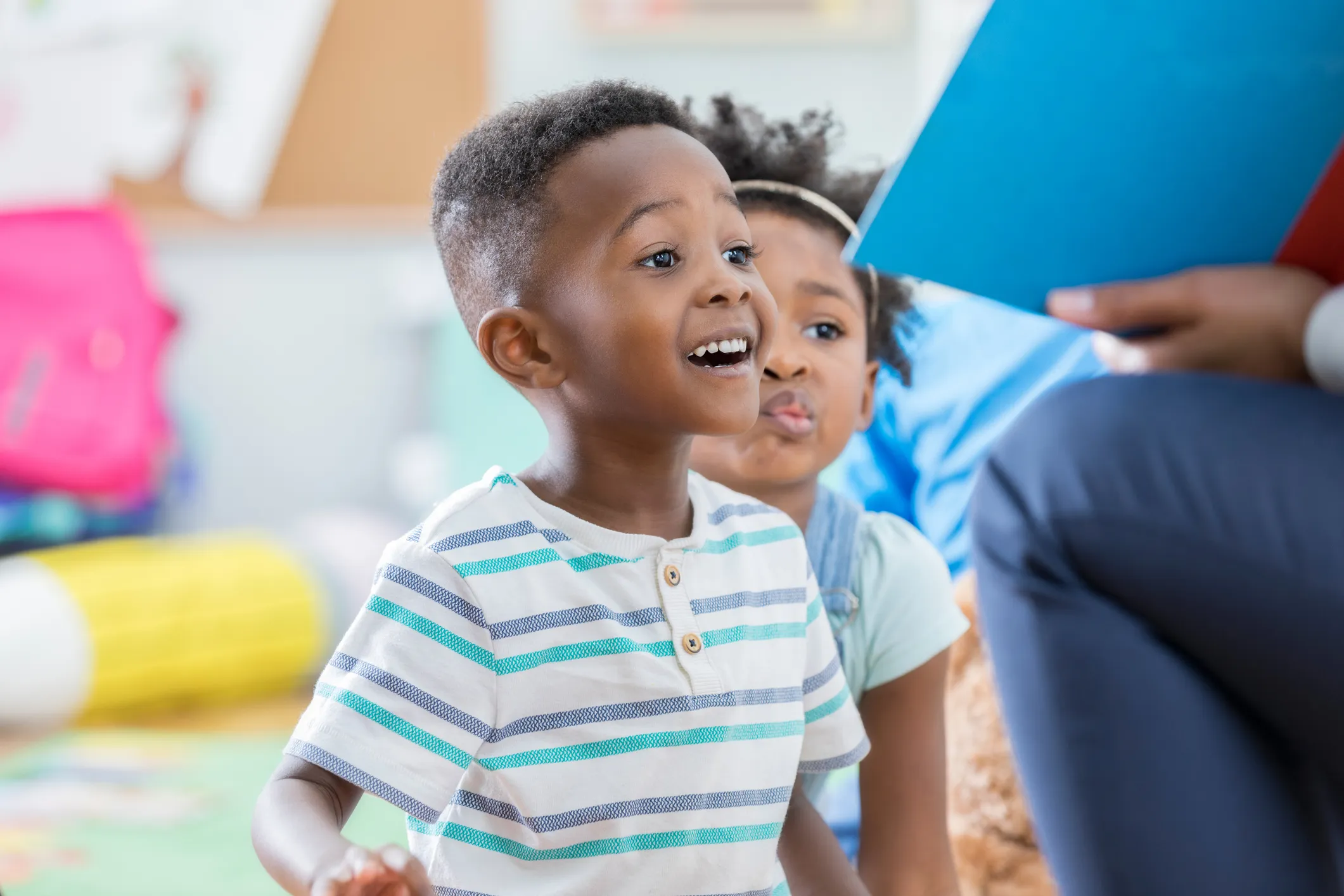 kid reading book with teacher's guidance