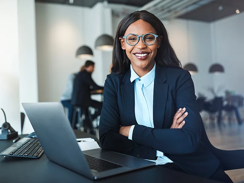 Woman wearing glasses at a computer