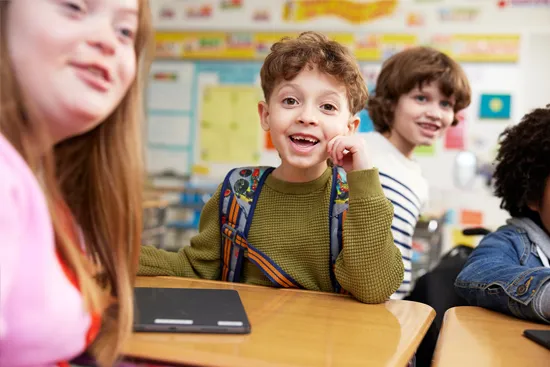 smiling students at their desks