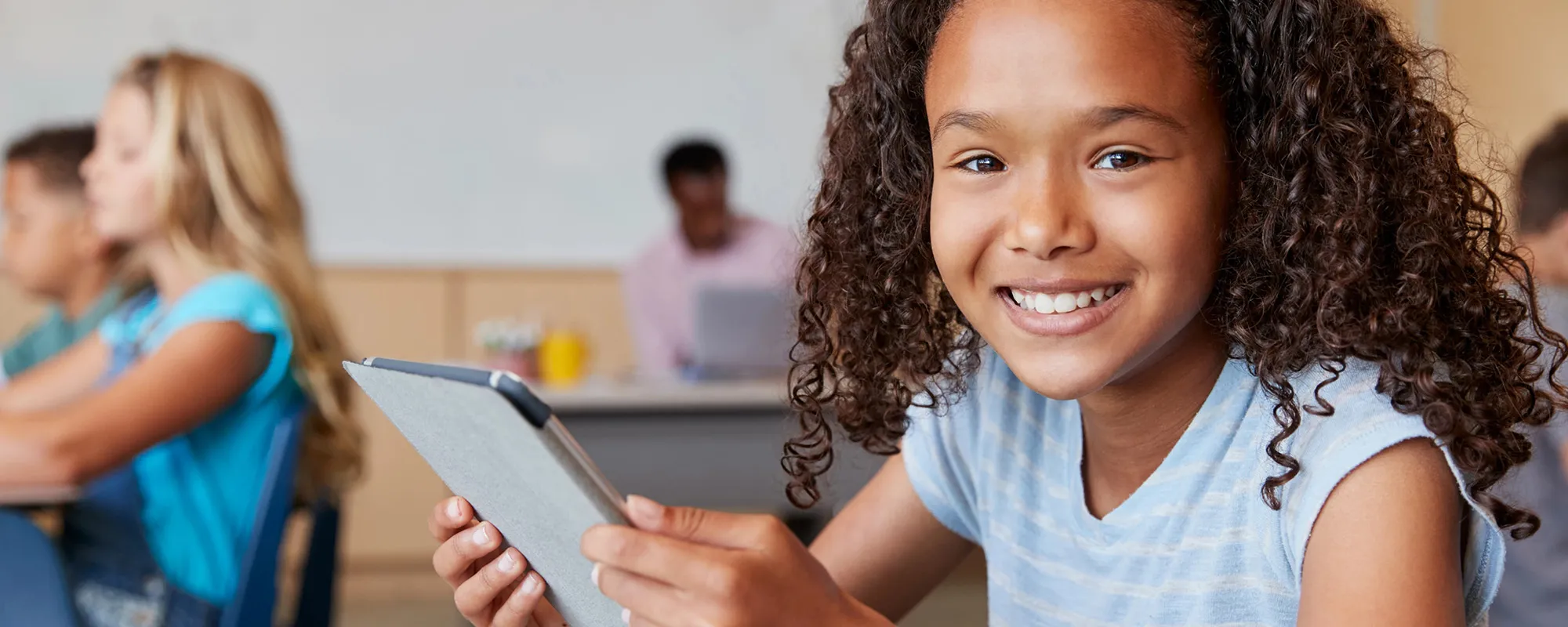 Smiling female student with tablet