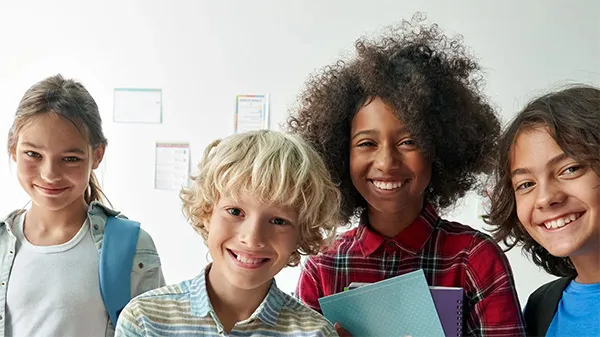 Group of smiling students in a classroom