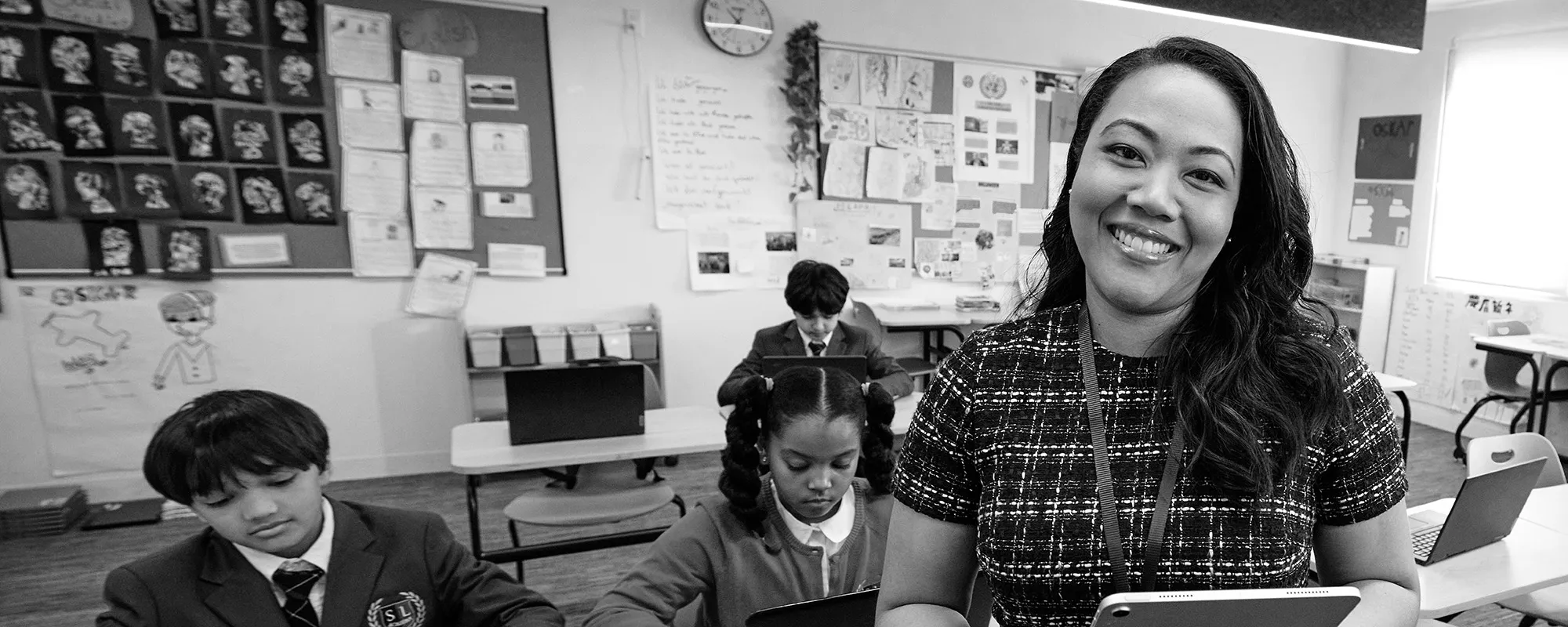 A smiling teacher in front of her classroom